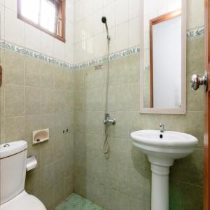 a bathroom with a toilet and a sink at RedDoorz near Trans Studio Mall Cibubur in Depok