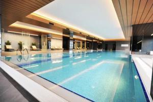 a large swimming pool in a building at Gorgeous 3bd2bath Bright Airy Penthouse! #355 in Istanbul