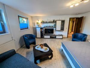 a living room with a bed and a table and a couch at Ferienwohnung Suchomski in Baabe