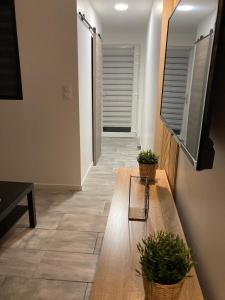 a living room with a bench and a television at Maisonnette in Magny-Jobert