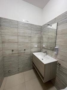 a bathroom with a sink and a mirror at The Diamond of Catania Airport in Catania +25 photos