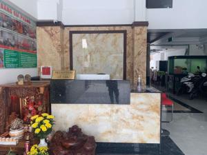 a lobby with a map on the wall and flowers at Love Hotel Hóc Môn in Ho Chi Minh City