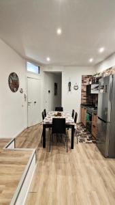 a kitchen and dining room with a table and a refrigerator at Antoinette Maison in Cefalù +31 photos