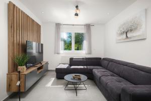a living room with a couch and a table at Plitvice house Angelina in Saborsko