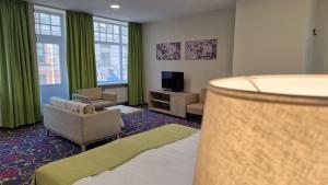 TV a/nebo společenská místnost v ubytování City Hotels Rūdninkai