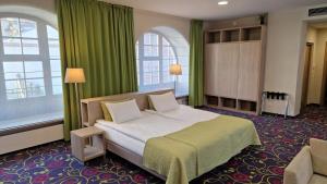 Postel nebo postele na pokoji v ubytování City Hotels Rūdninkai