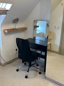 an office with a black desk and a chair at Home in Gorgeous Gort in Gort