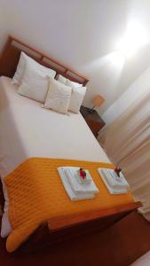 a bedroom with a bed with two towels on it at Casa Oliveira - Algarve in Porches +31 photos
