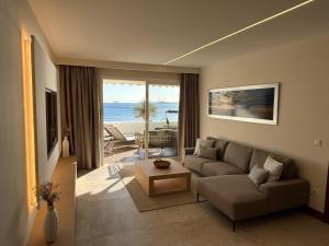 a living room with a couch and a view of the ocean at Costa Teguise luxury first line apartment in Costa Teguise