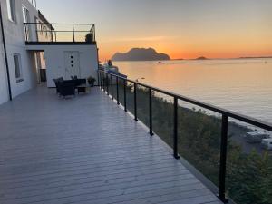 a balcony of a house with a view of the water at Fjord view in centre with parking in Ålesund