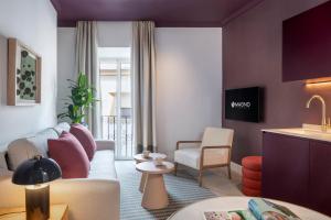 a living room with a couch and a table at Casa Bedoya Suites & Colors by Magno Apartments in Seville
