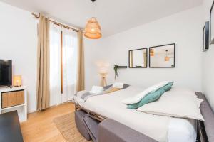 a bedroom with a large bed and a tv at Maison savorani in Cap d'Ail