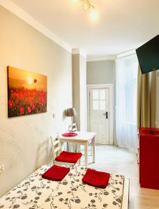 a room with a table and two chairs and a table at Colourful Rooms Wrocław in Wrocław