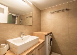 a bathroom with a sink and a washing machine at YestayHomes Two Bedroom Apartment Anagnostopoulou in Athens