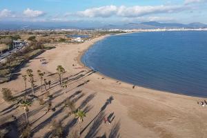 an overhead view of a beach with palm trees and people at L éden mer et piscine appartement 53 m2 in Saint-Aygulf
