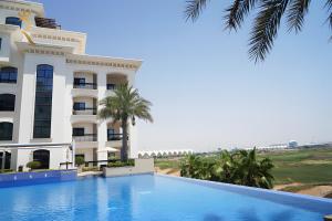 una vista del hotel desde la piscina en Elegant 2BR Golf View Oasis in Yas Island - Maids Room, Pool & Near Yas Mall, en Yas Island