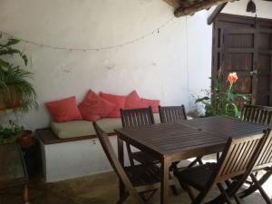 a living room with a couch with red pillows at La Carrihuela Amarilla in Algodonales
