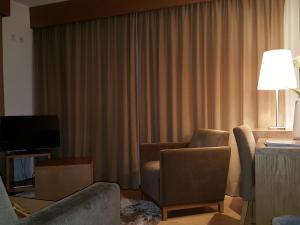 Uma TV ou centro de entretenimento em Hotel Jose Alberto