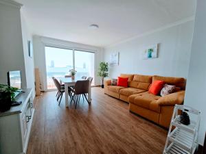 a living room with a couch and a table at VV Milenaiver "by henrypole home" in Los Cancajos