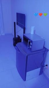 a blue room with a desk with a computer on it at prety in Yof +2 photos