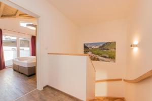 A bed or beds in a room at Grossglockner Chalets Zell am See