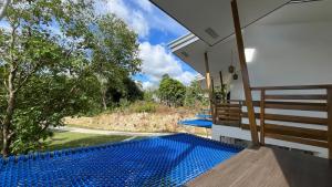 a view of a swimming pool from the balcony of a house at ThePureYann in San Juan