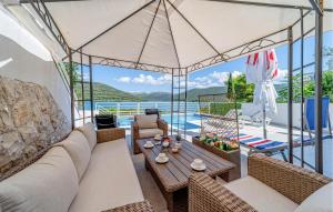 a living room with a couch and a table at Cozy Home In Ston With Wifi in Ston +40 photos