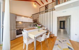 a kitchen and dining room with a table and chairs at Cozy Home In Ston With Wifi in Ston