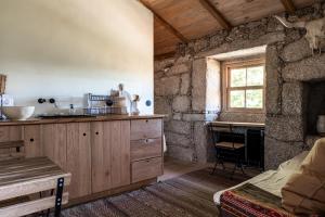 a kitchen with a sink and a counter with a window at Levada da Breca - Turismo Rural in Ervedeiros