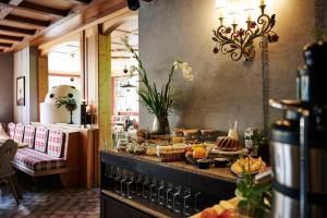 a table with food on a counter in a restaurant at Arlberg Stuben - das kleine, feine Hotel in Stuben am Arlberg