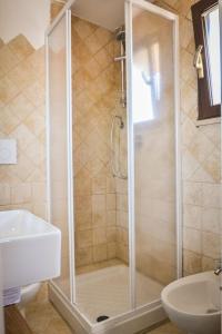 a shower with a glass door in a bathroom at Il Mare a Roma - Attico Fronte Mare in Lido di Ostia