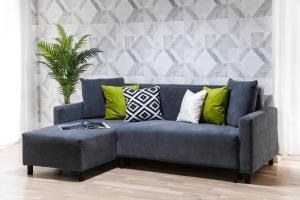 a blue couch with green pillows in a living room at Sara - Stylish Apt with Balcony near Piata Obor in Bucharest