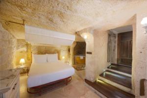 A bed or beds in a room at Tafoni Houses Cave Hotel