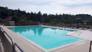 a large swimming pool with chairs and an umbrella at Floating House Sea Queen in Portorož