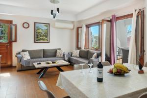 a living room with a couch and a table at Voula Apartment in Ermoupoli