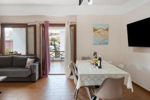 a living room with a table and a couch at Voula Apartment in Ermoupoli