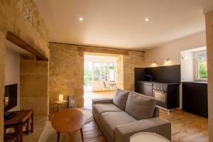 a living room with a couch and a table at L'Épicerie de Bezenac in Bézenac