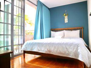 a bedroom with a bed with a blue wall at Family Pent House in Seoul