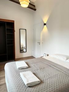a bedroom with a large bed with two towels on it at Heaven Homes - 15 Gehmin bis zur Innenstadt in Düsseldorf