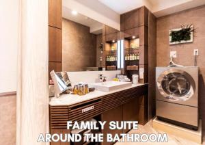 a bathroom with a sink and a washing machine at Hotel Pasela Living Shinjuku in Tokyo