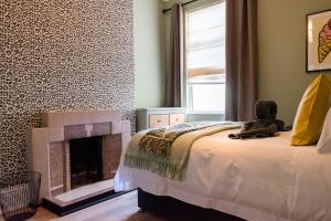 a bedroom with a bed and a fireplace at The Parade -Corner Plot Getaways in Redcar