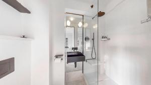 a bathroom with a sink and a mirror at Sloane Cloisters 767 in London