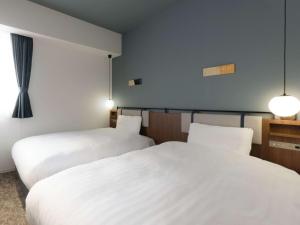 Кровать или кровати в номере Comfort Hotel Yokkaichi
