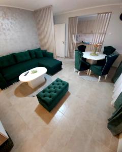 a living room with a green couch and a table at Tiha Voda 1 in Požarevac +44 photos