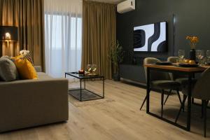a living room with a couch and a table at Luca - Luxury Park-View Apt with Balcony & Parking in Bucharest