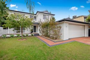 a large white house with a garage at SERENITY STAYS Mount Martha Mornington Peninsula in Mount Martha