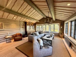 a living room with a couch and a table at Large cabin with spectacular views in Geilo in Geilo