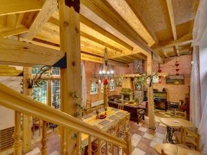 a large living room with wooden ceilings and a table at Holiday Home Gościniec Pod Dwoma Sercami by Interhome in Tuplice +44 photos