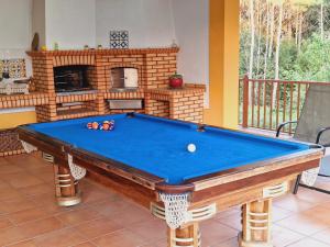 a pool table in a living room with a fireplace at Casa dos Trigais in Marco de Canaveses
