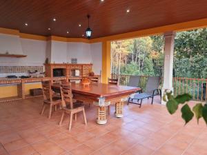 a dining room with a large wooden table and chairs at Casa dos Trigais in Marco de Canaveses